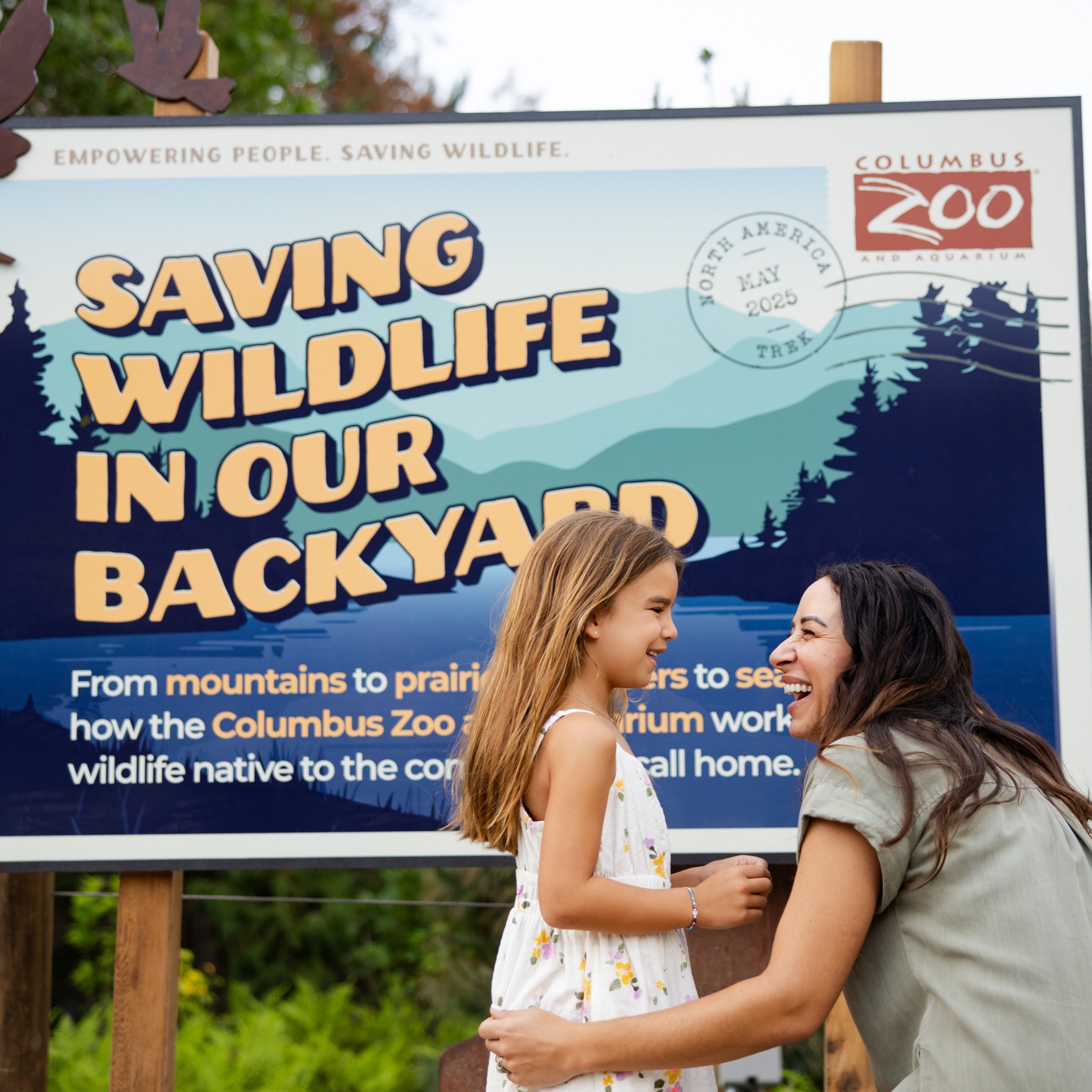 family in front of zoo signage