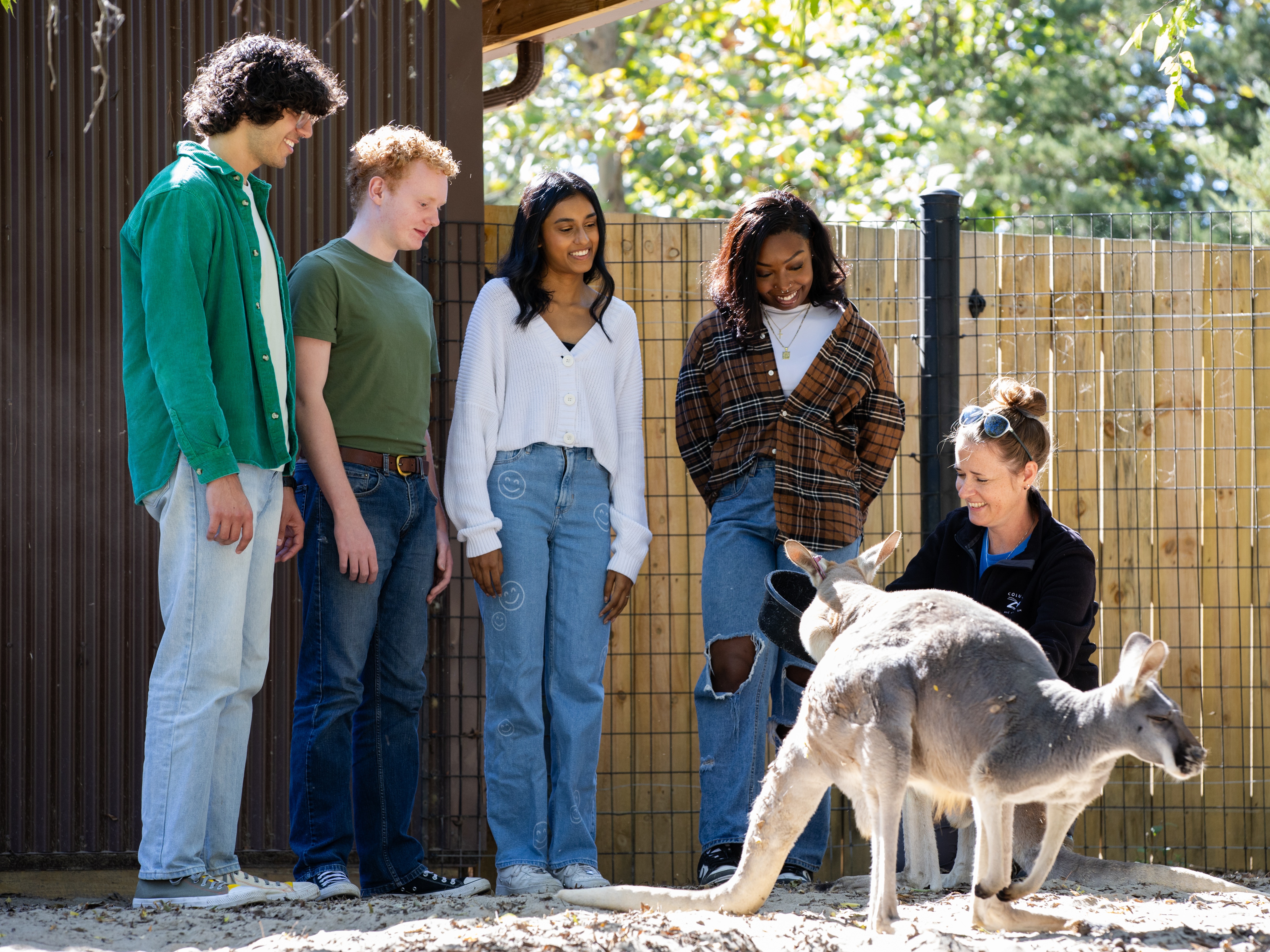 zoo guests watching zookeeper presentation