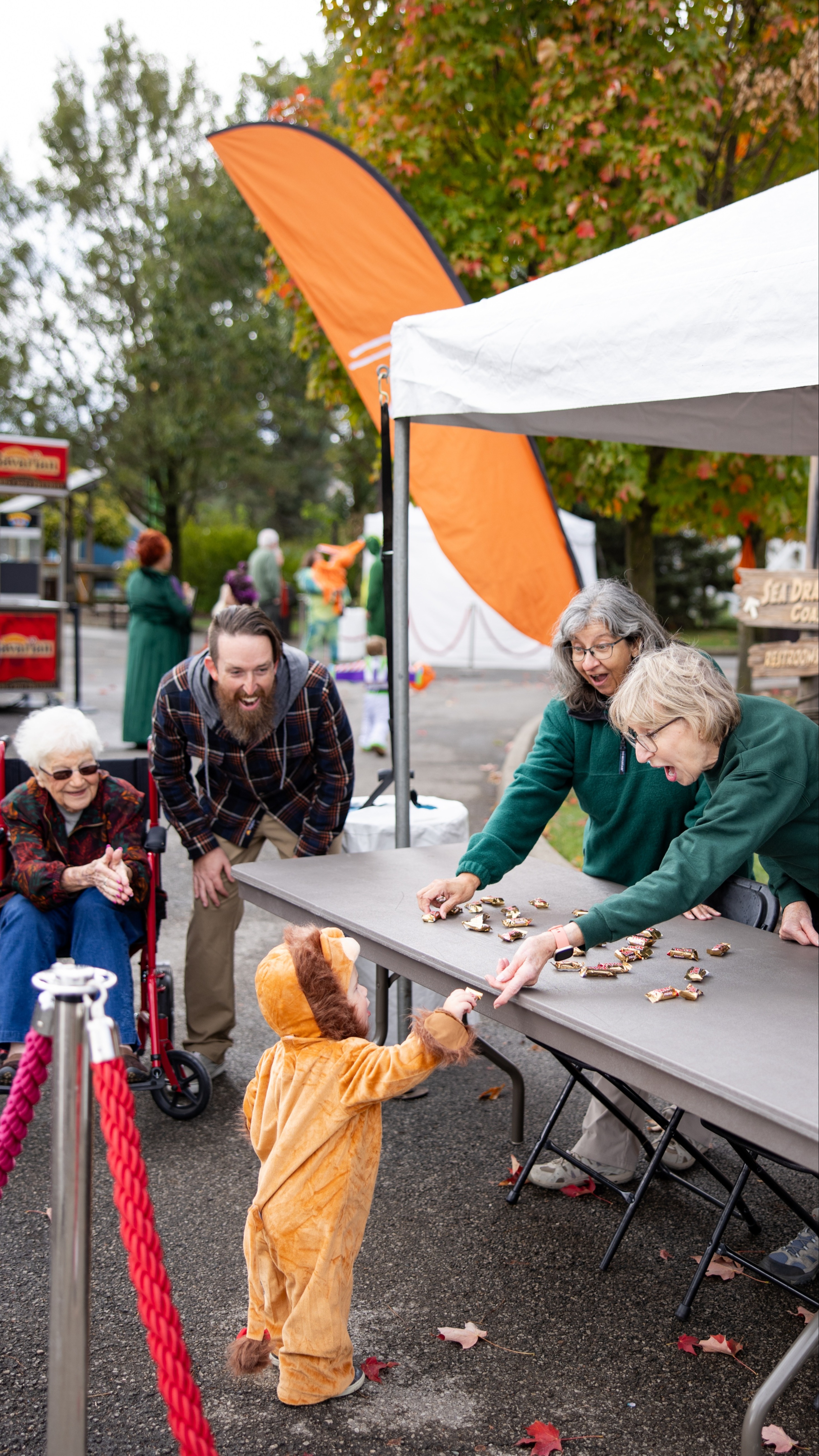zoo volunteers giving candy to child