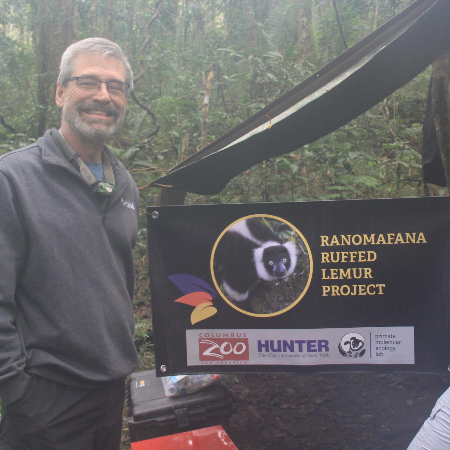 Randy Junge next to lemur sign