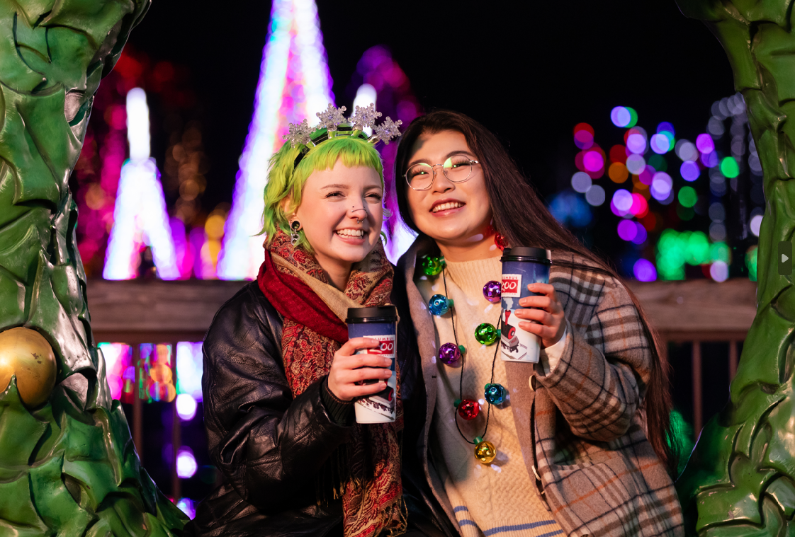 Wildlights guests holding drink cups and smiling