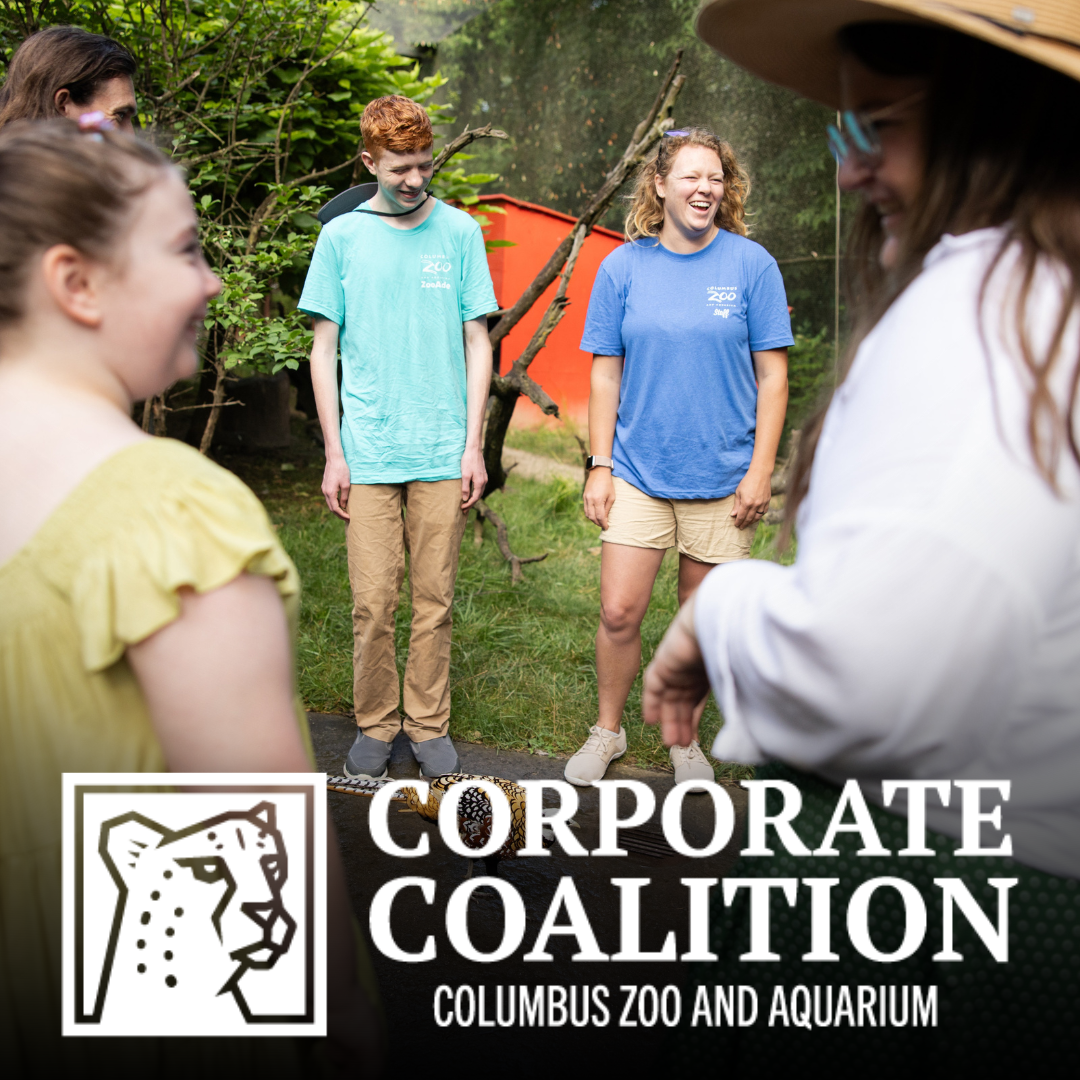 Zoo guests smiling and talking with employee