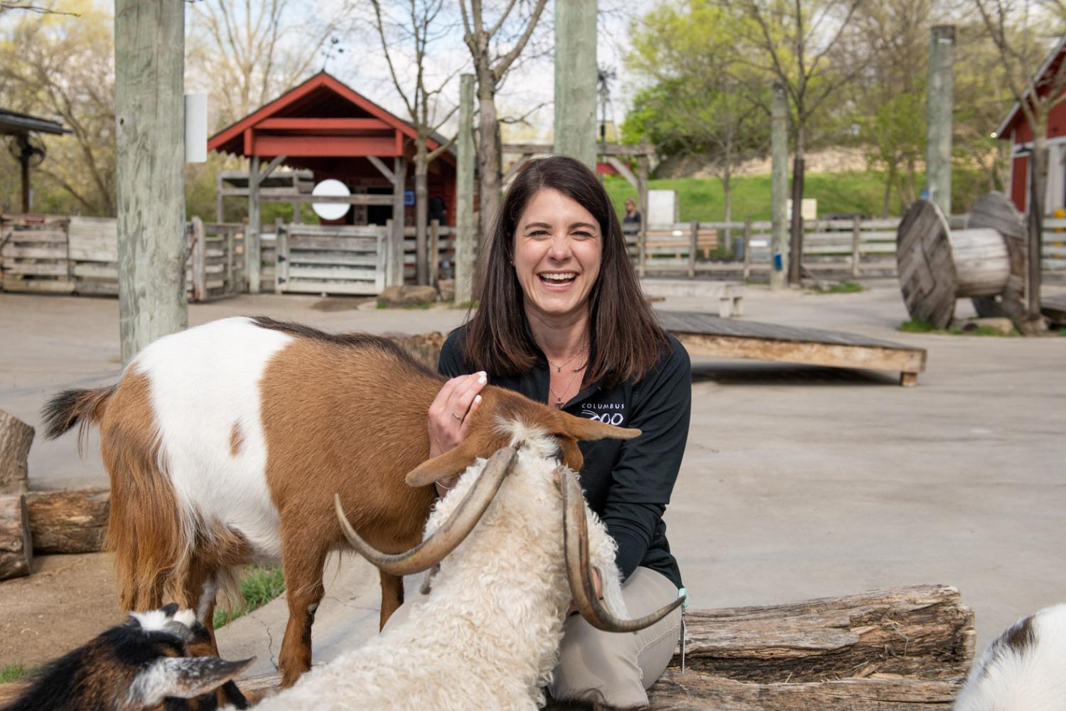 Caitlin Garling and farm animals at the Zoo