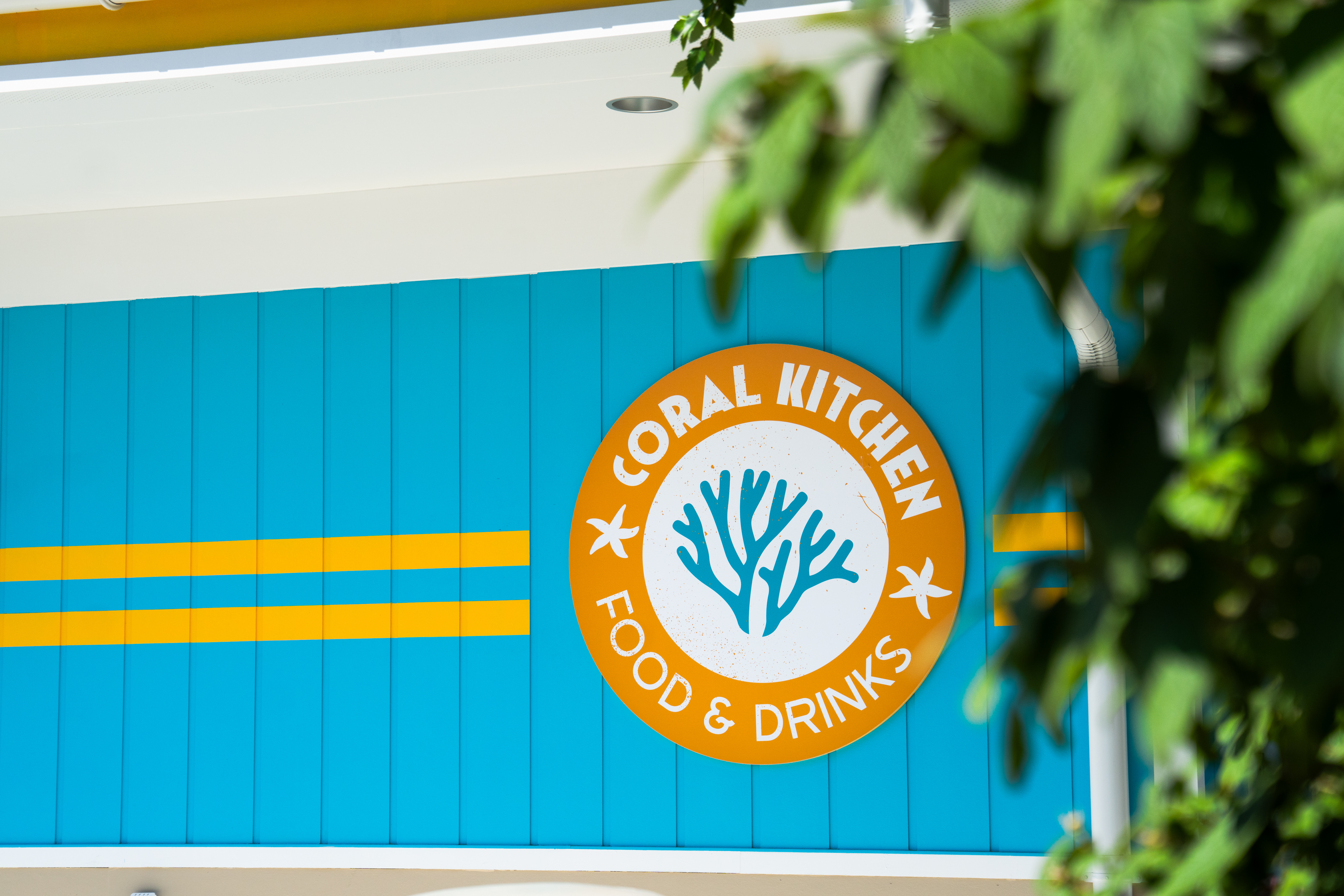 Coral Kitchen sign on blue building