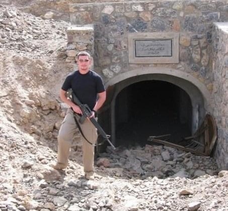 military member in front of building entrance