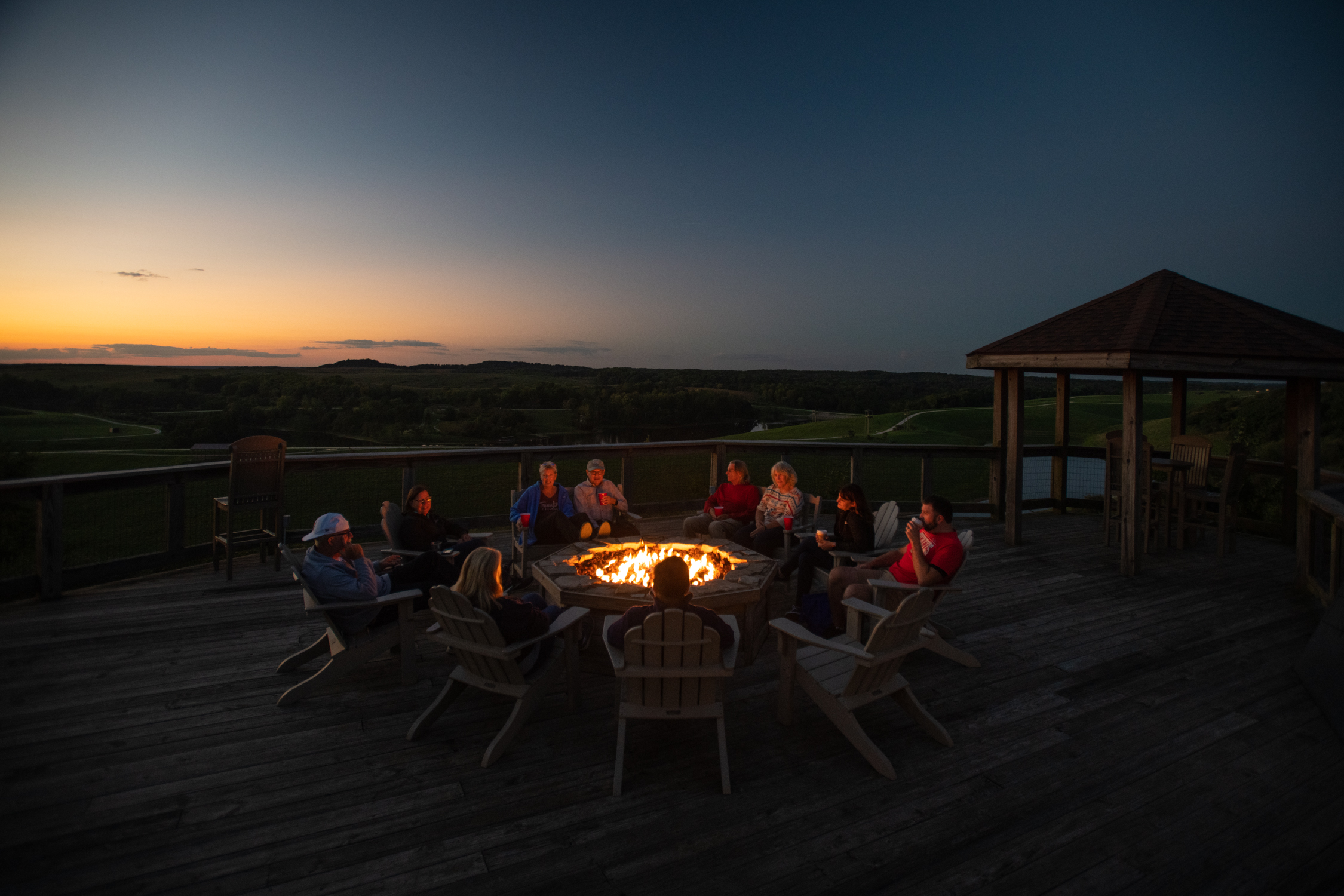 overnight guests at The Wilds around a bonfire