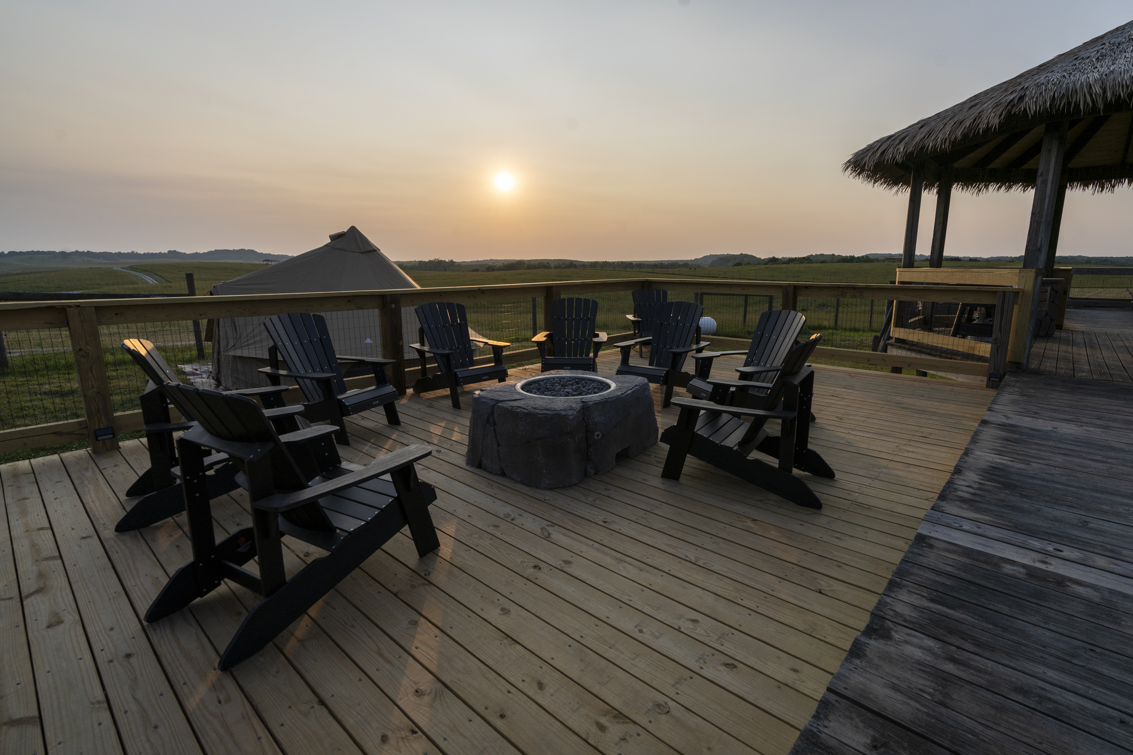 outpost camping site at The Wilds, chairs in circle around a firepit