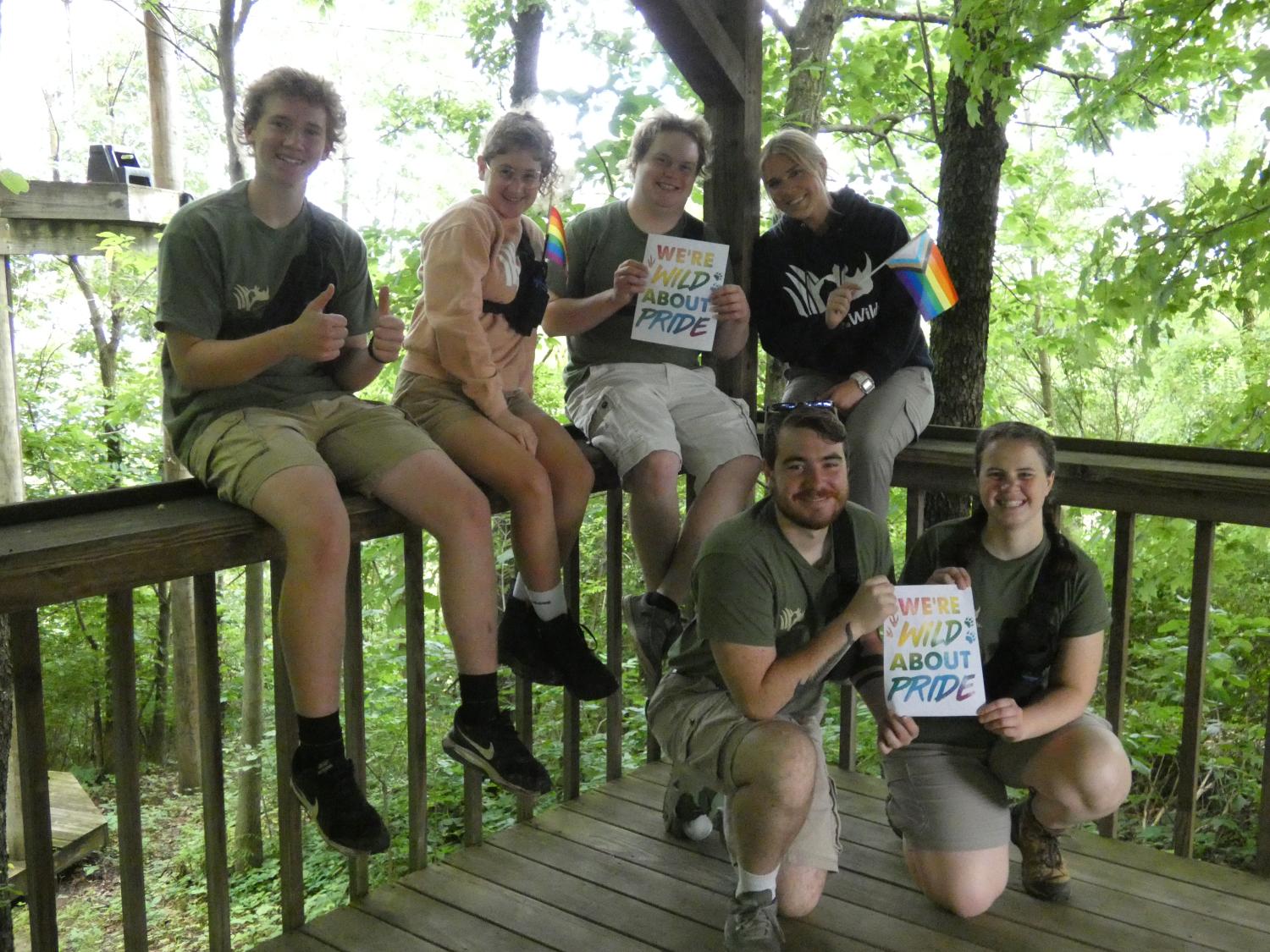 staff members sitting on fence