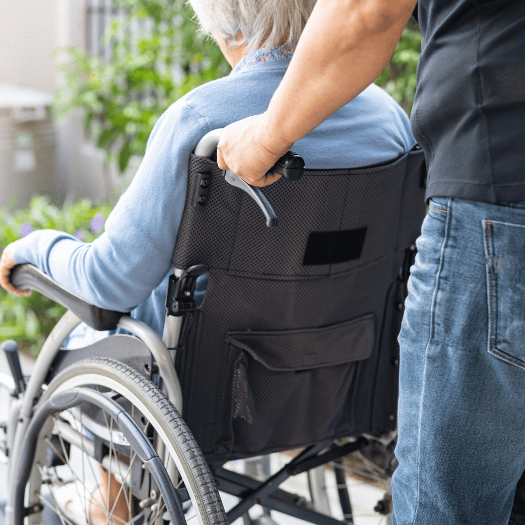 man pushing woman in wheelchair