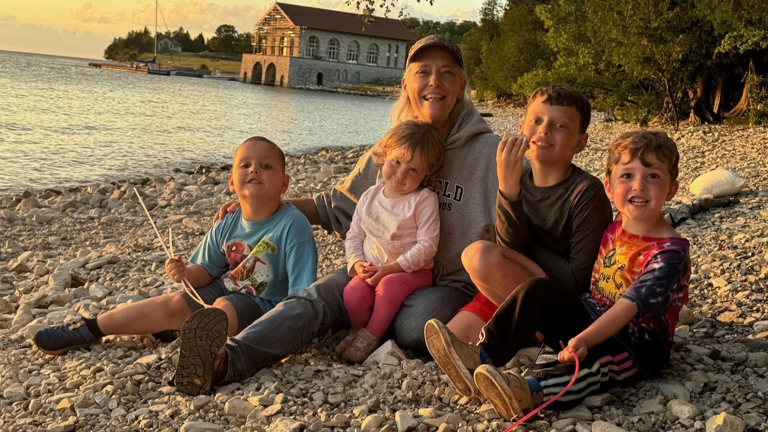 family posing for photo on beach
