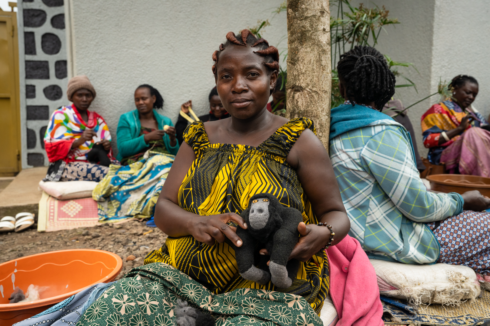woman in rwanda, holding a plush gorilla