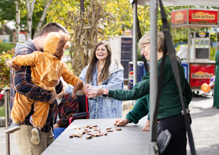 zoo volunteer giving candy to zoo guests