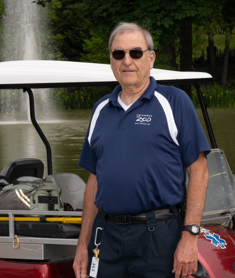 man in front of golf cart and lake