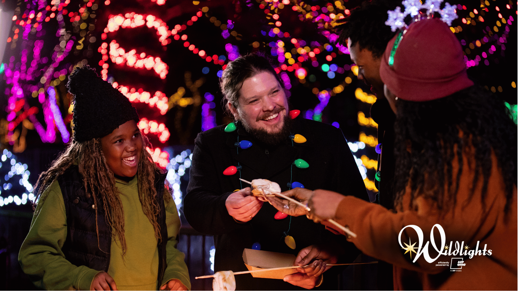 three zoo guests smiling, holding s'mores