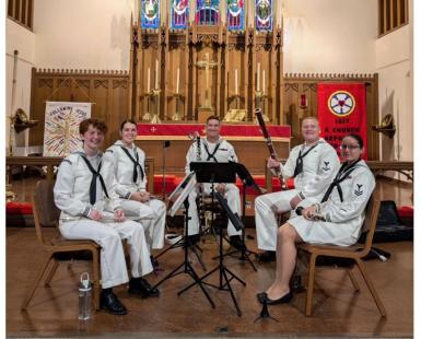 navy personnel holding instruments