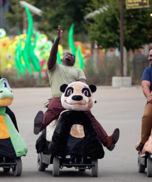 zoo guests on scooters