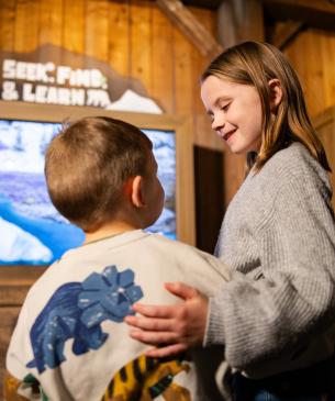 children looking at each other in indoor setting