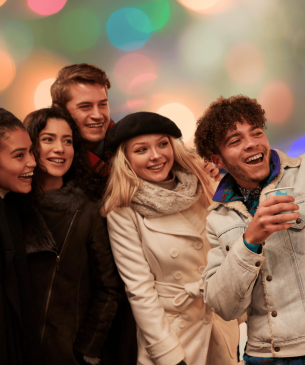 guests smiling with faint lights behind them