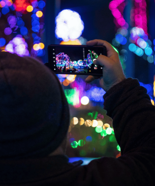 Zoo guest taking video of holiday lights