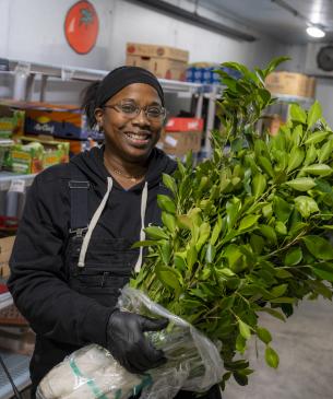 woman holding branch bundle