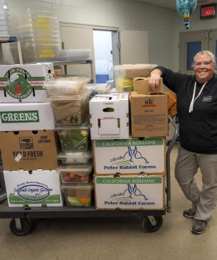 team member posing by food
