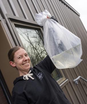 woman holding bag of fish