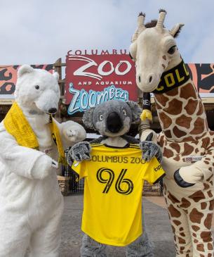 mascots holding columbus crew jersey