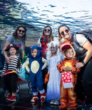 family smiling in aquarium tunnel
