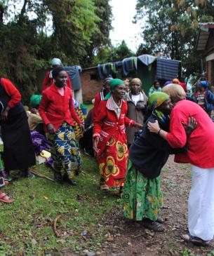 Charlene hugging women in Rwanda