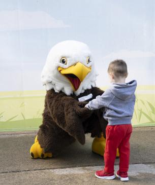 mascot and child talking