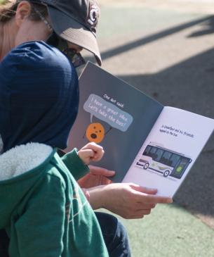 woman reading to child at zoo