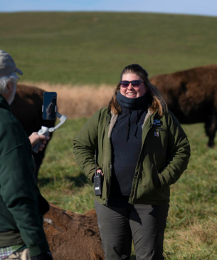 woman in pasture with bison