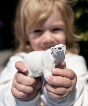child holding polar bear toy