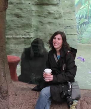 woman posing near gorilla habitat