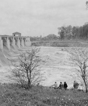 River dam with people in foreground looking at it