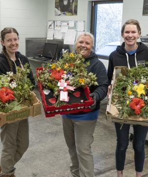 three women holding food containers