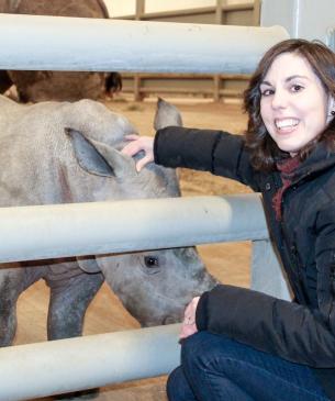 woman posing with rhino