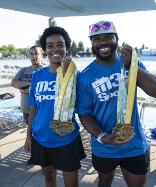 runners holding medals and smiling