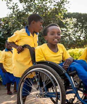 children in yellow uniform shirts playing