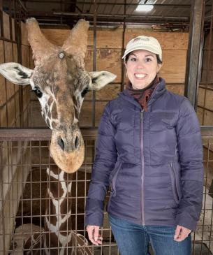 woman posing with giraffe