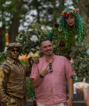 man posing for photo with performing artist