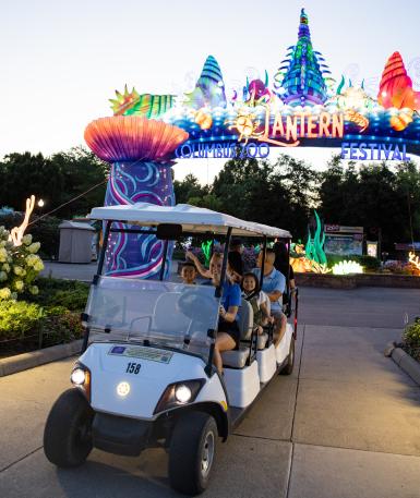 VIP lantern tour, golf cart in foreground of event entrance arch