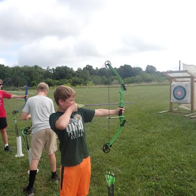 Child holding archery bow