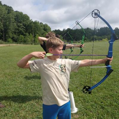 child holding archery bow