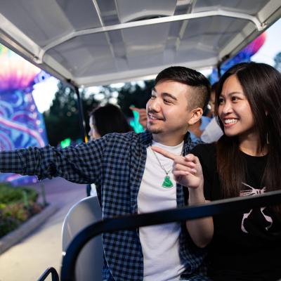 two zoo guests on golf cart
