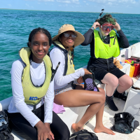 students on boat in clear water