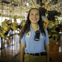 zoo employee smiling near carousel