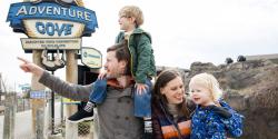 Family walking at the Columbus Zoo near Adventure Cove sign