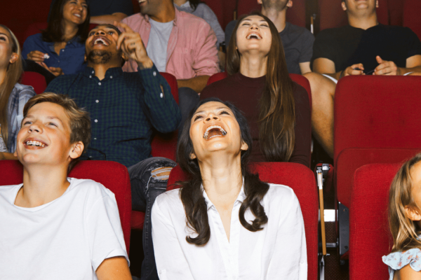 guests laughing in movie theater