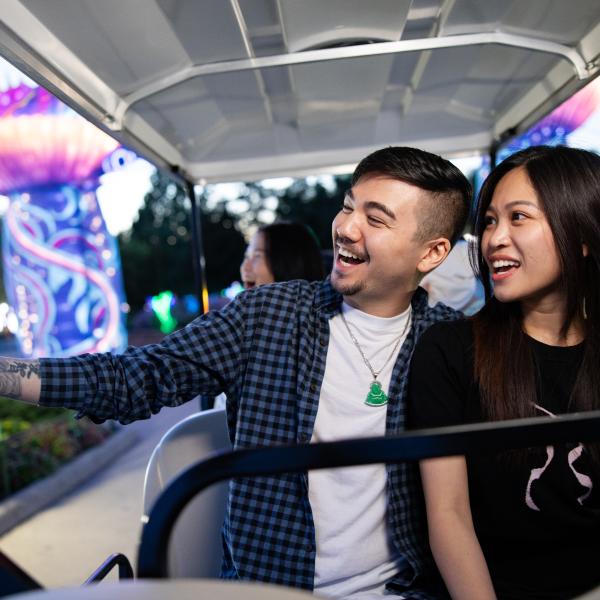 two zoo guests on golf cart